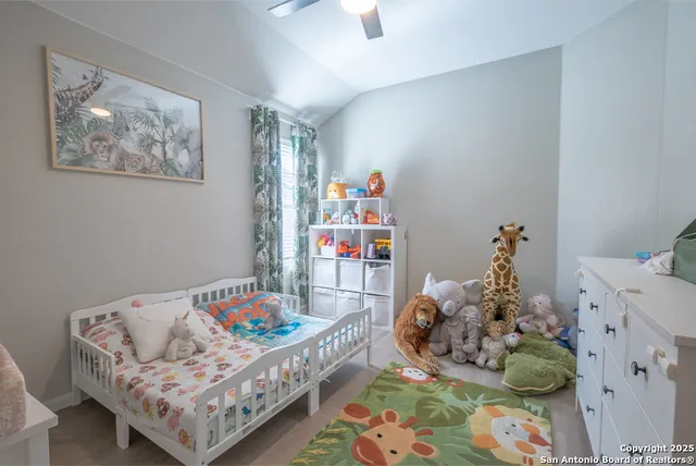 a bedroom with baby toys and wooden floor