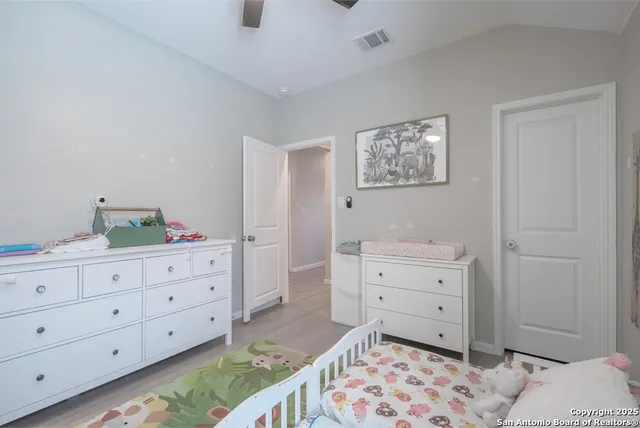 a bedroom with a bed and a dresser in it