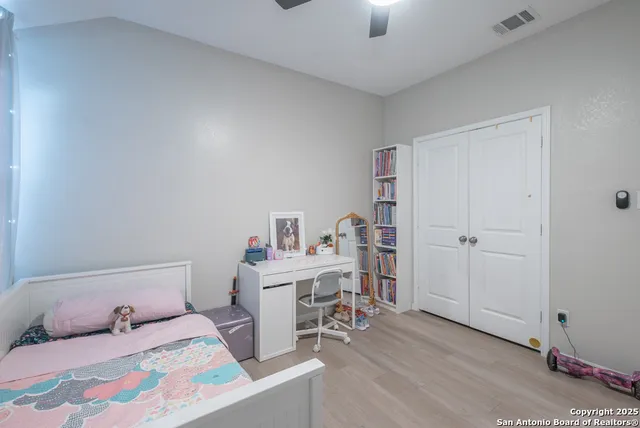 a bedroom with furniture and a wooden floor