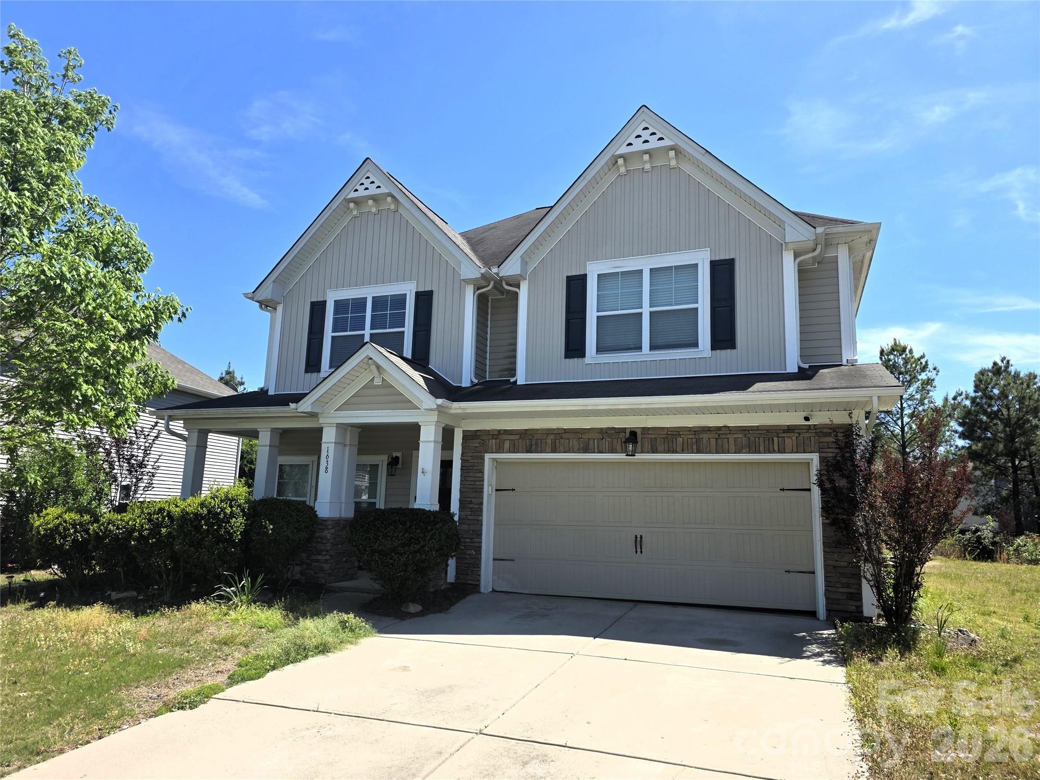 a front view of a house with a yard and garage