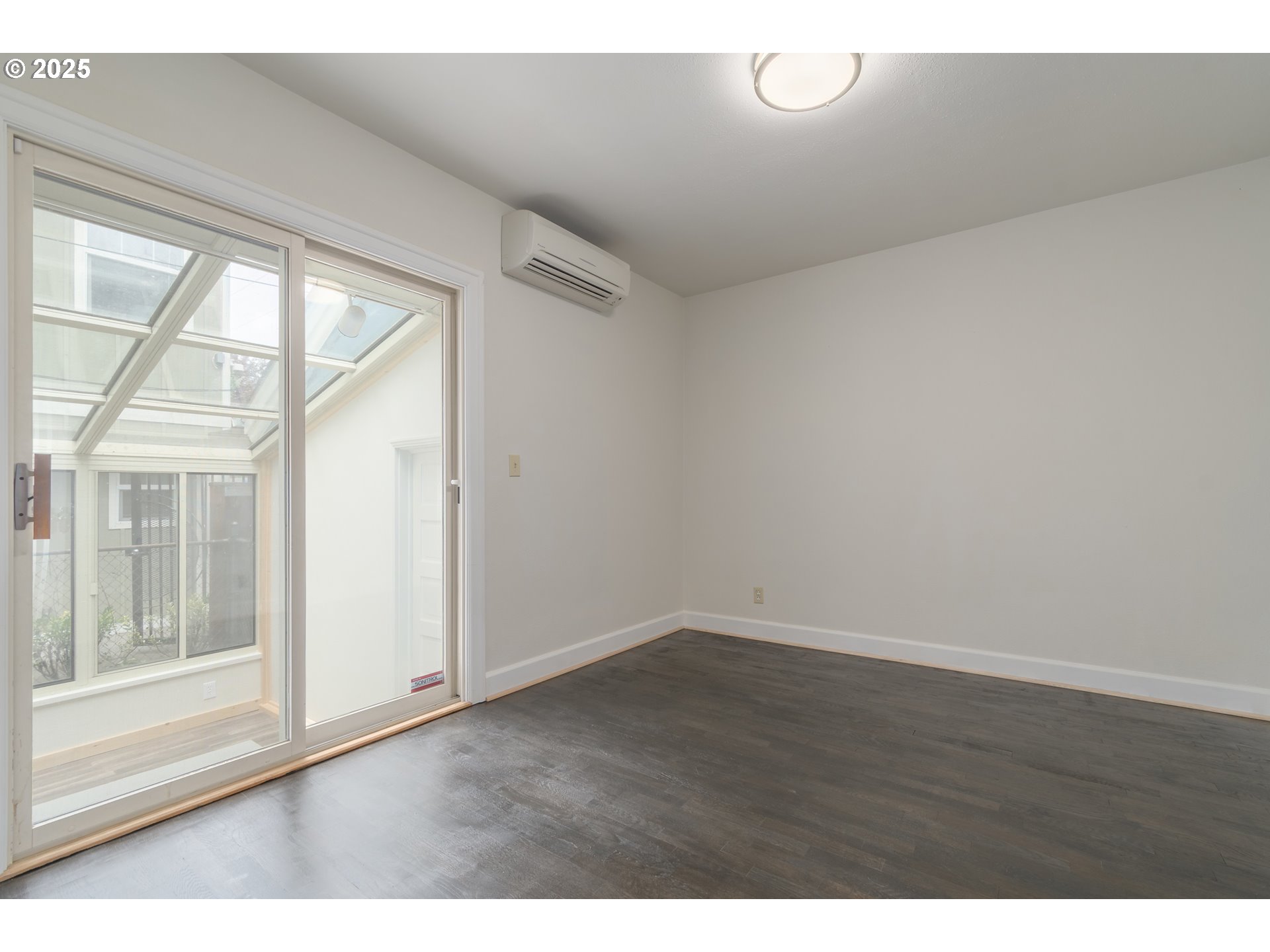 960 Washington Street Eugene, OR 97401 - Photo 26 of 43 a view of an empty room with wooden floor and a window