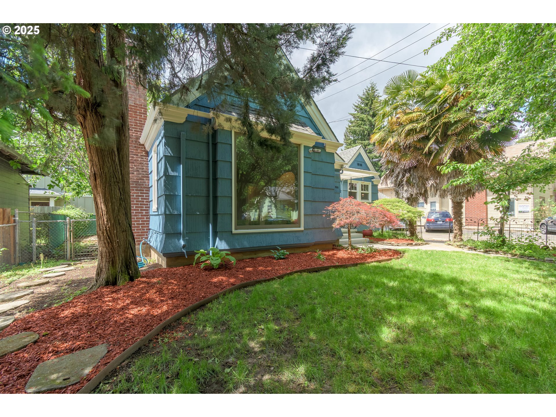 960 Washington Street Eugene, OR 97401 - Photo 10 of 43 a view of a yard in front of a house with a large tree