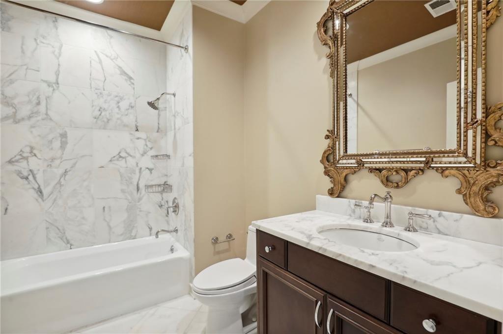 1965 West Wesley Road Northwest Atlanta, GA 30327 - Photo 18 of 34 a bathroom with a granite countertop sink toilet and shower