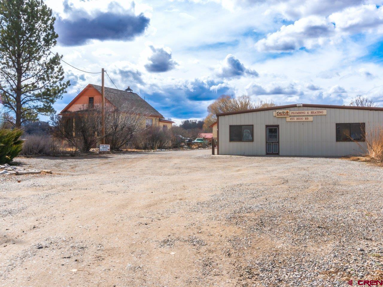 477 1600 Road Delta, CO 81416 - Photo 3 of 23 a view of a white house with a yard