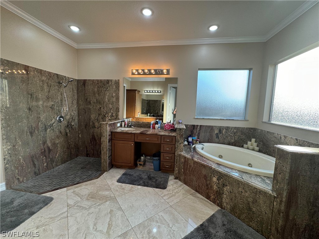 2408 River Way LaBelle, FL 33935 - Photo 17 of 21 a bathroom with a tub a sink a mirror and a shower