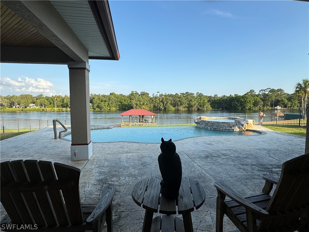 2408 River Way LaBelle, FL 33935 - Photo 18 of 21 a view of a lake from a balcony with furniture and a lake view