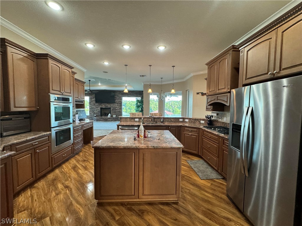 2408 River Way LaBelle, FL 33935 - Photo 5 of 21 a large kitchen with stainless steel appliances granite countertop a sink refrigerator and cabinets