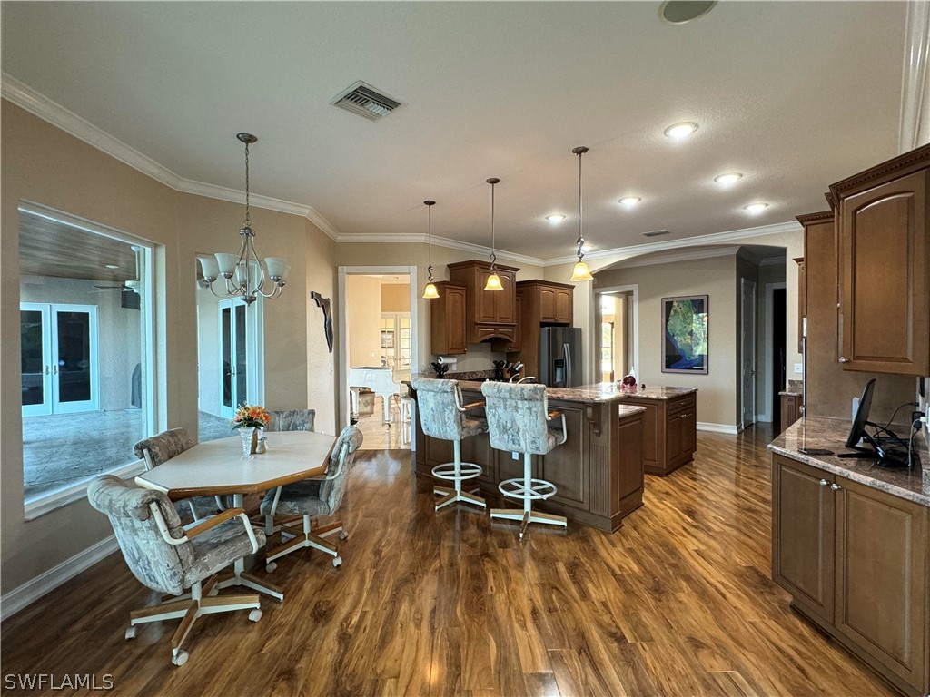 2408 River Way LaBelle, FL 33935 - Photo 6 of 21 a view of a dining room with furniture window and wooden floor