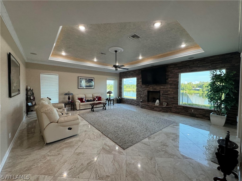 2408 River Way LaBelle, FL 33935 - Photo 7 of 21 a living room with furniture a fireplace and a flat screen tv