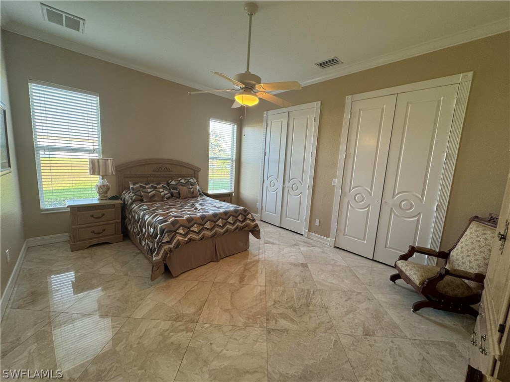 2408 River Way LaBelle, FL 33935 - Photo 9 of 21 a bedroom with a bed and a chandelier