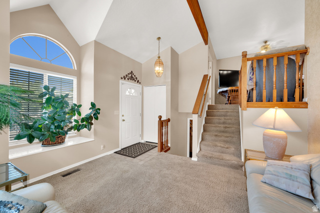 8029 Angel Street Sandy, UT 84070 - Photo 3 of 21 Vaulted ceilings with exposed wood beams, a prominent arched window, and a white paneled entry door