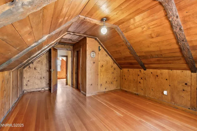 a view of a room with wooden floor