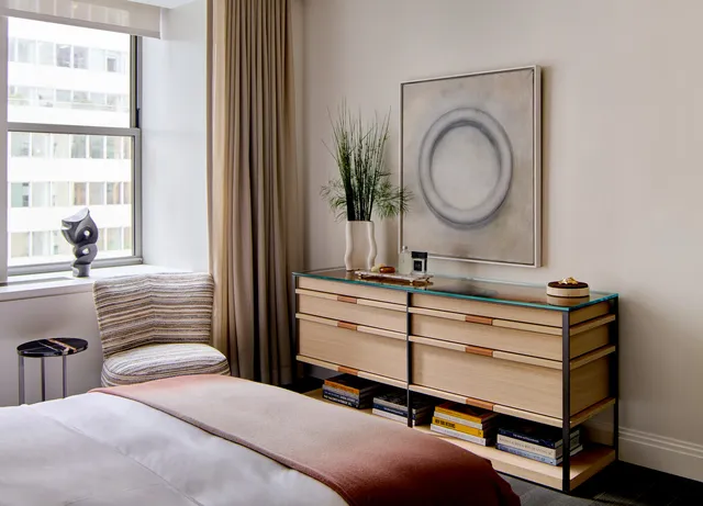 a bedroom with a bed and a mirror