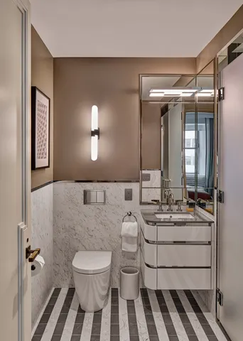 a bathroom with a double vanity sink mirror and toilet