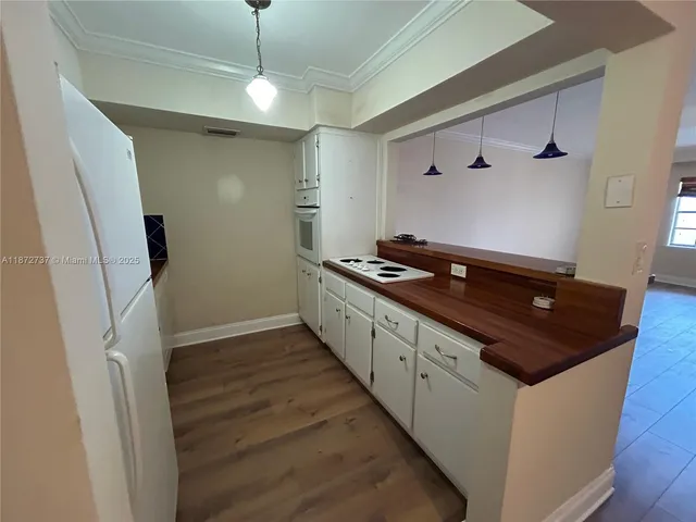 a kitchen with granite countertop a stove and a refrigerator