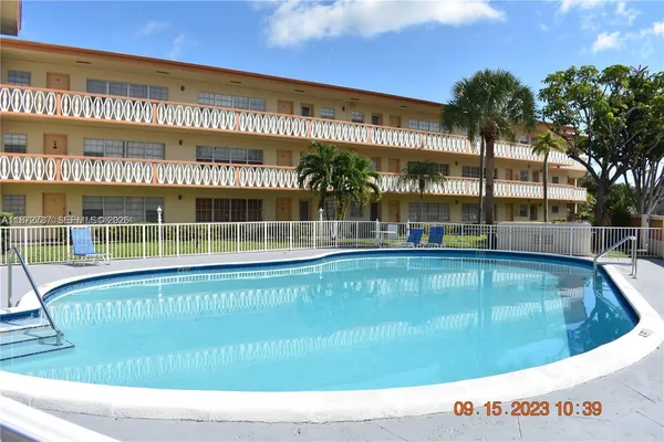 a view of a swimming pool with outdoor seating