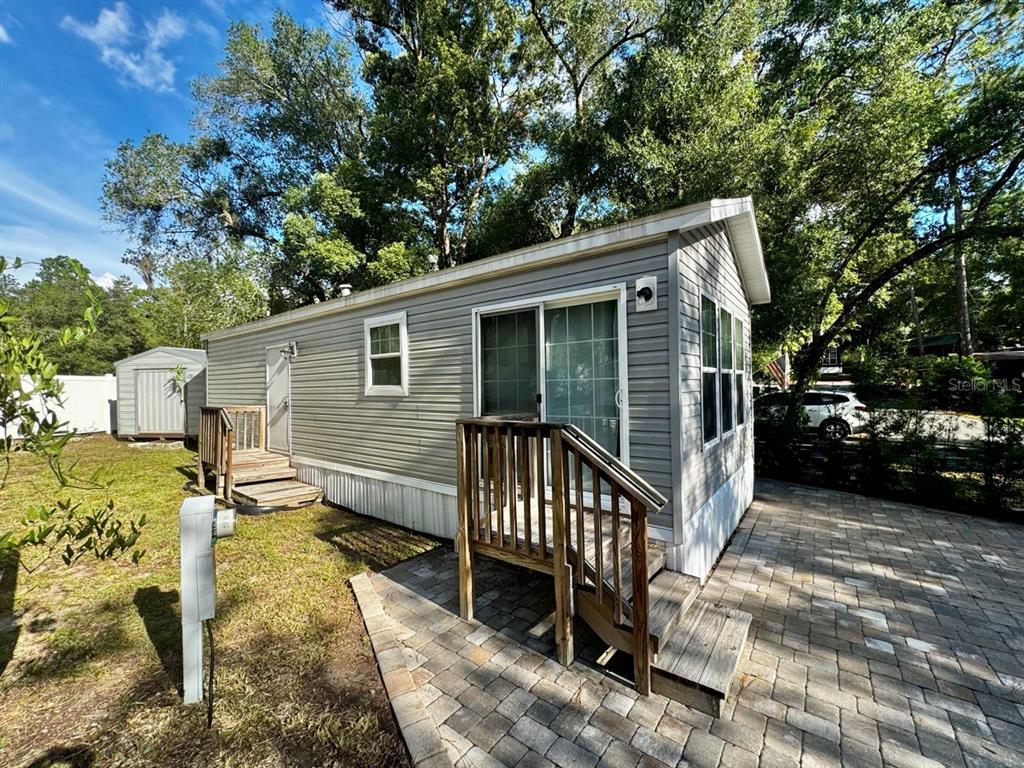 14365 Northeast 252nd Ct Road, Unit 123 Salt Springs, FL 32134 - Photo 24 of 44 a view of a house with a yard deck and furniture