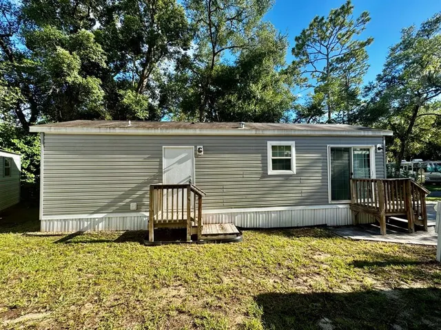 a view of a chair and table in the backyard