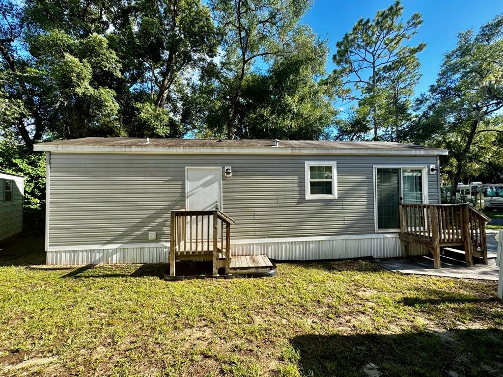 14365 Northeast 252nd Ct Road, Unit 123 Salt Springs, FL 32134 - Photo 25 of 44 a view of a chair and table in the backyard