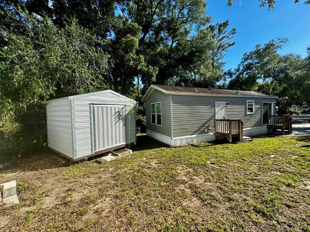 14365 Northeast 252nd Ct Road, Unit 123 Salt Springs, FL 32134 - Photo 26 of 44 a view of a house with a yard