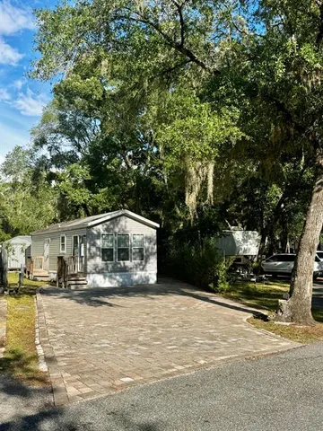 a view of house with outdoor space and sitting area