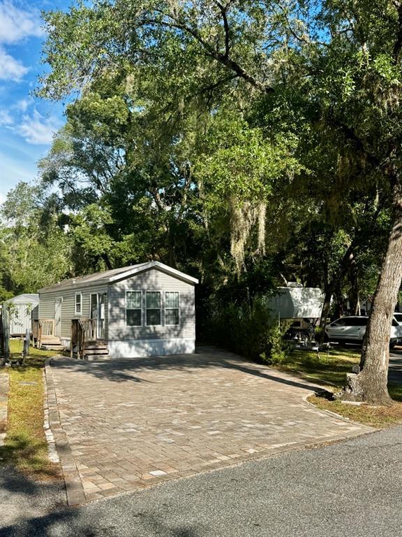 14365 Northeast 252nd Ct Road, Unit 123 Salt Springs, FL 32134 - Photo 28 of 44 a view of house with outdoor space and sitting area