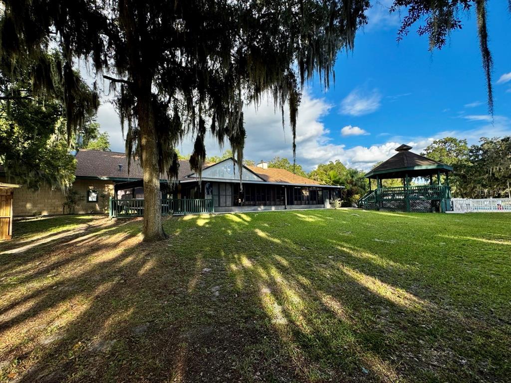 14365 Northeast 252nd Ct Road, Unit 123 Salt Springs, FL 32134 - Photo 42 of 44 a view of a park with palm trees