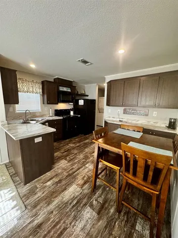 a kitchen with a stove a sink and a microwave