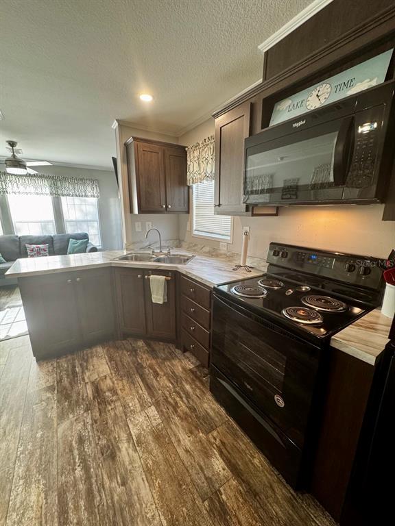14365 Northeast 252nd Ct Road, Unit 123 Salt Springs, FL 32134 - Photo 8 of 44 a large kitchen with granite countertop a stove and a sink