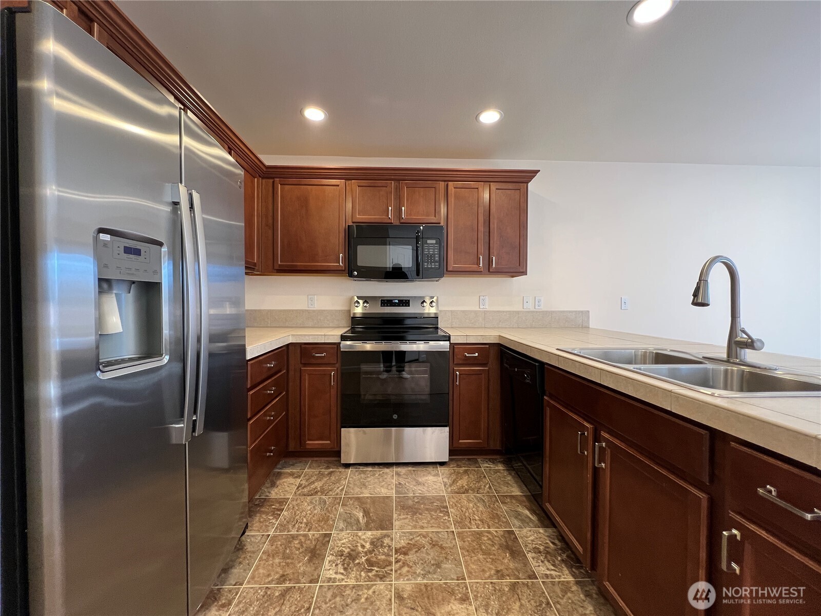 5447 57th Loop Southeast Lacey, WA 98503 - Photo 11 of 31 a kitchen with a sink cabinets and stainless steel appliances
