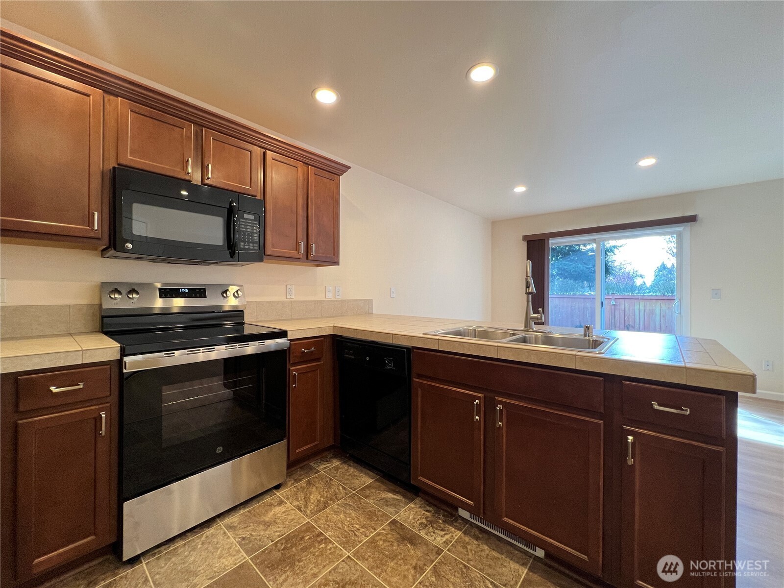 5447 57th Loop Southeast Lacey, WA 98503 - Photo 12 of 31 a kitchen with a sink and steel appliances