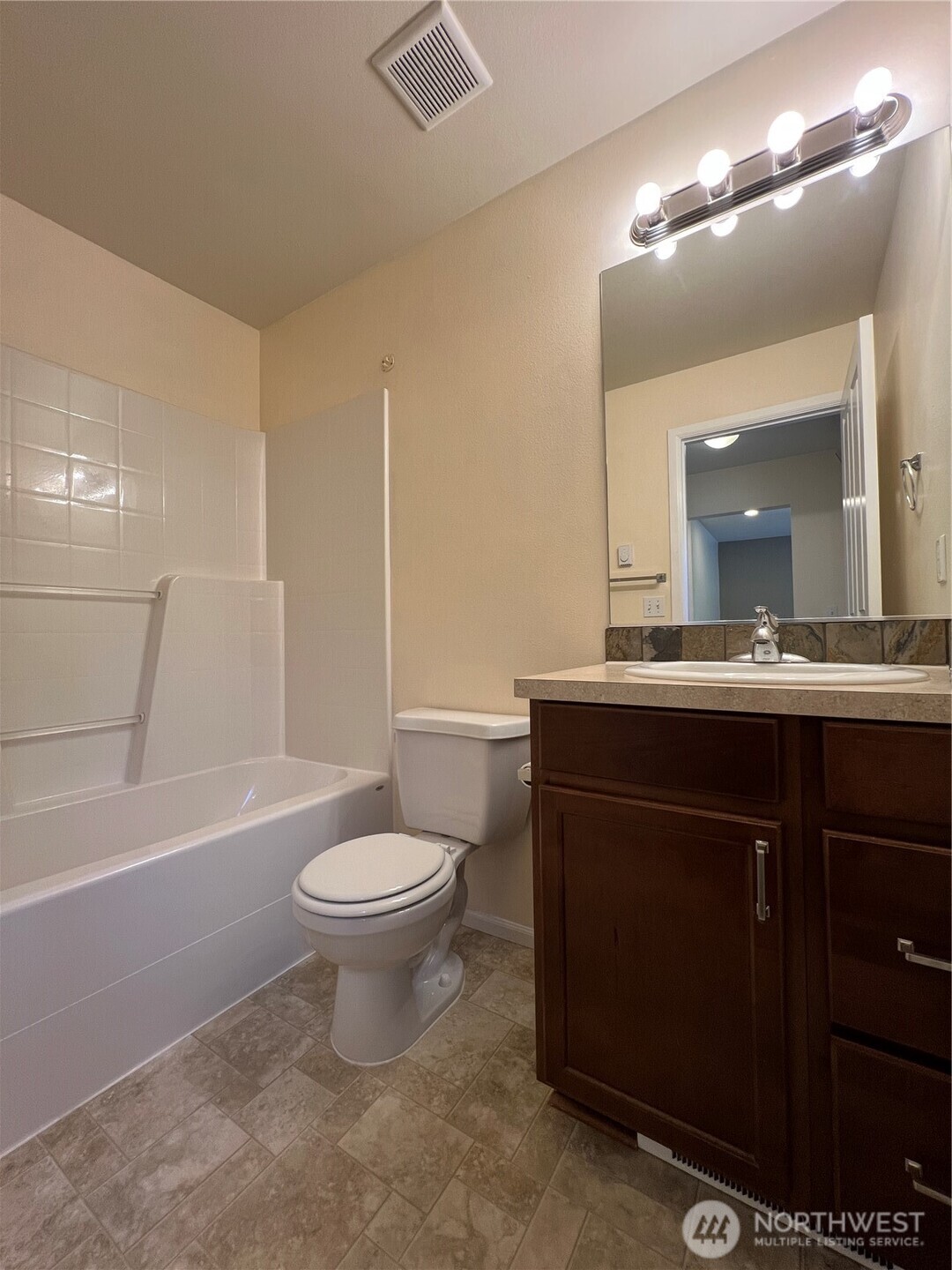 5447 57th Loop Southeast Lacey, WA 98503 - Photo 28 of 31 a bathroom with a sink a toilet a mirror and bathtub