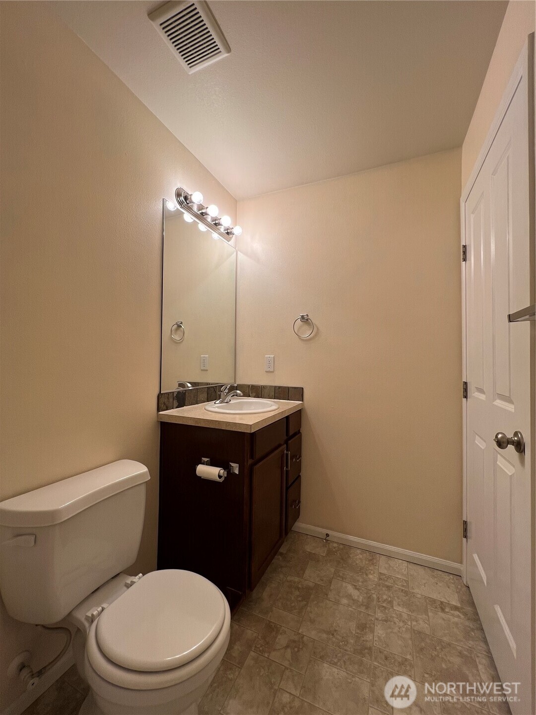 5447 57th Loop Southeast Lacey, WA 98503 - Photo 30 of 31 a bathroom with a sink a toilet and vanity
