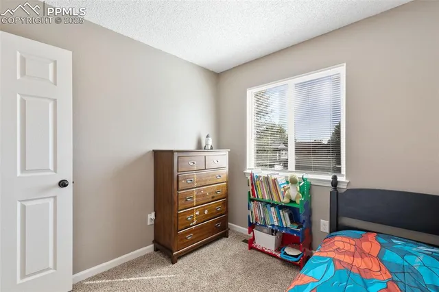a bedroom with furniture and a window
