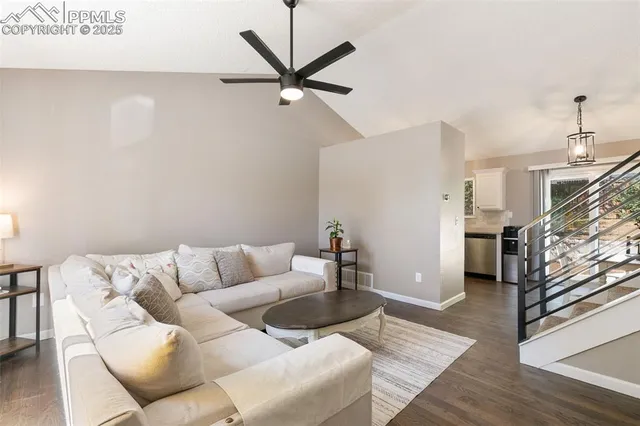 a living room with furniture and a ceiling fan