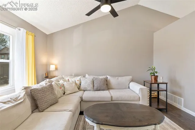 a living room with furniture and a potted plant