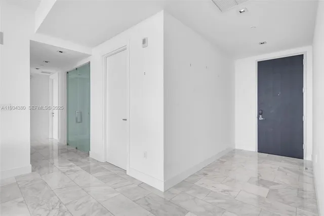 a spacious bedroom with a bed and a large window