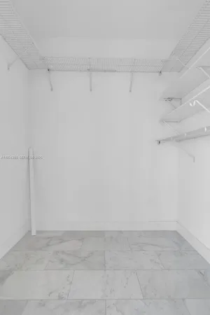 a view of a hallway with wooden shelves