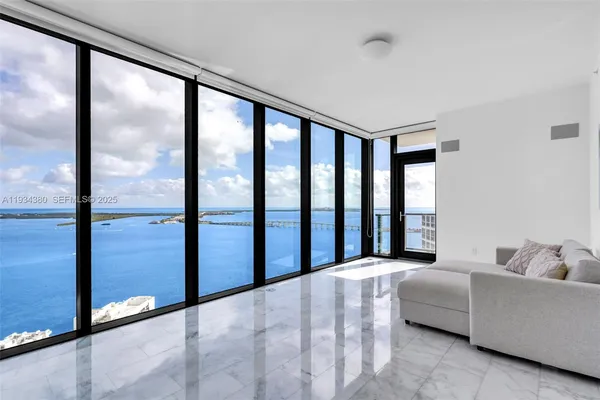 a spacious bedroom with a large bed and a large window