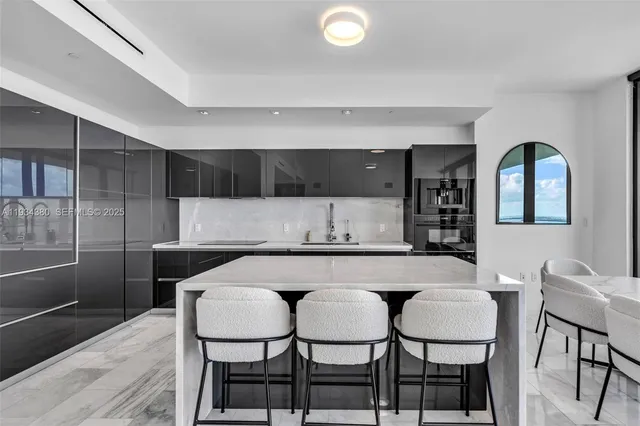 a kitchen with a table and chairs in it
