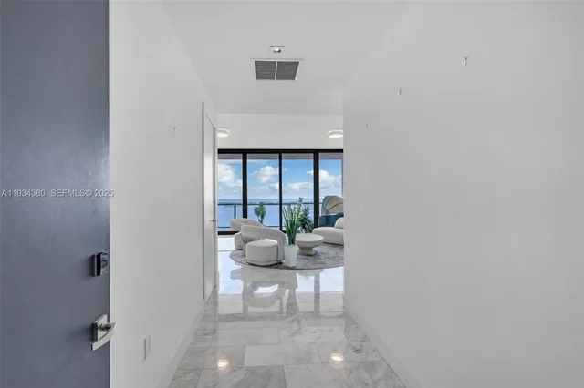 a living room with furniture and large window