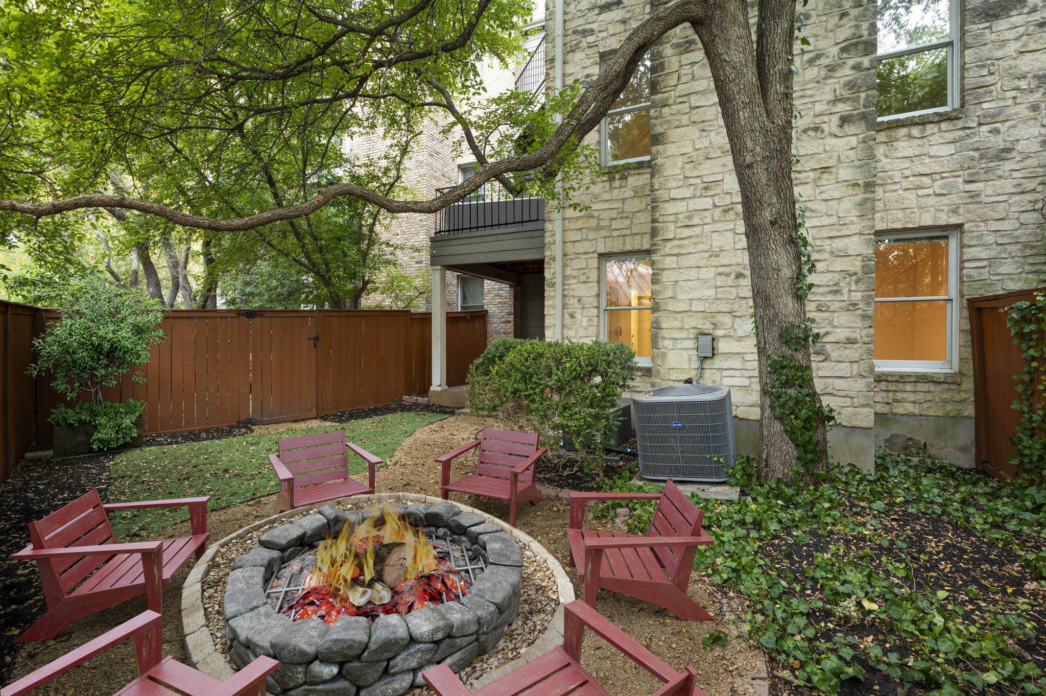 6010 Long Champ Court, Unit 113 Austin, TX 78746 - Photo 12 of 25 Fenced backyard featuring a patio and an outdoor fire pit