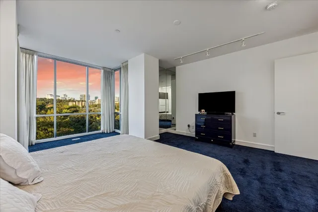 a bedroom with a bed and a television