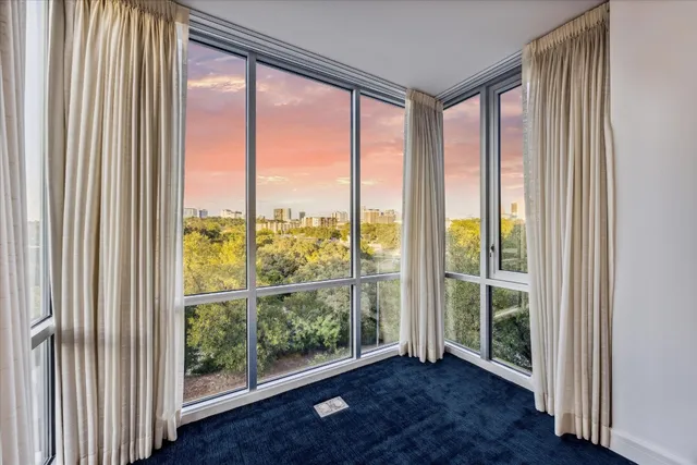 a view of an empty room and wooden floor and windows