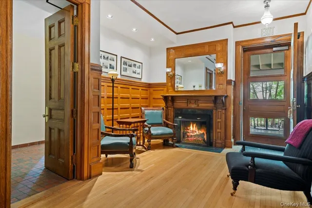 a living room with furniture a fireplace and a flat screen tv