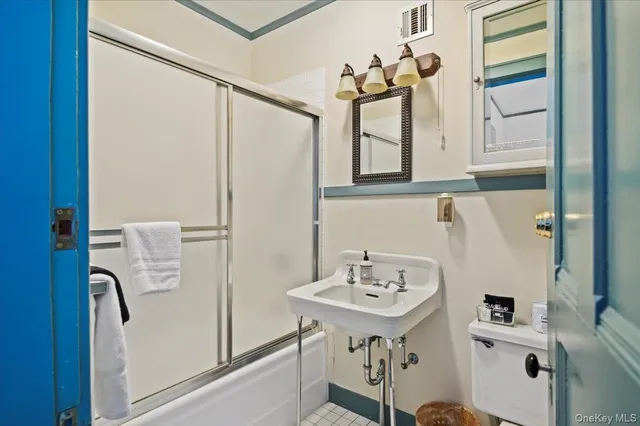 a bathroom with a sink a mirror and a toilet