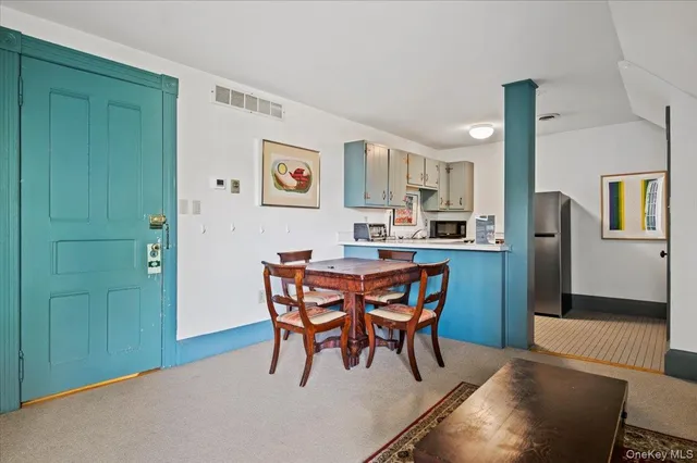 a dining room with furniture and window