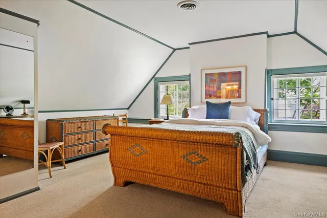 a bed sitting in a bedroom next to a window