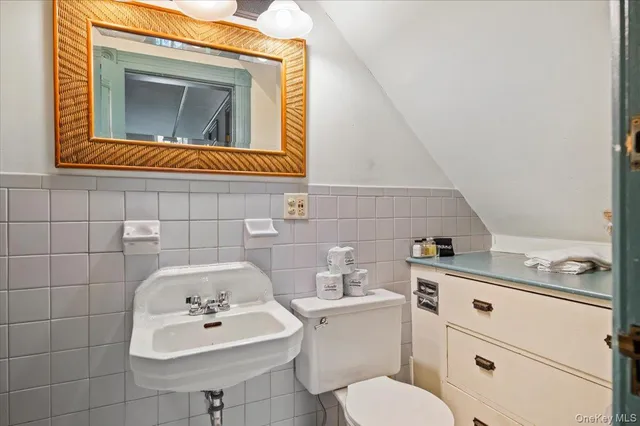 a bathroom with a sink toilet and mirror
