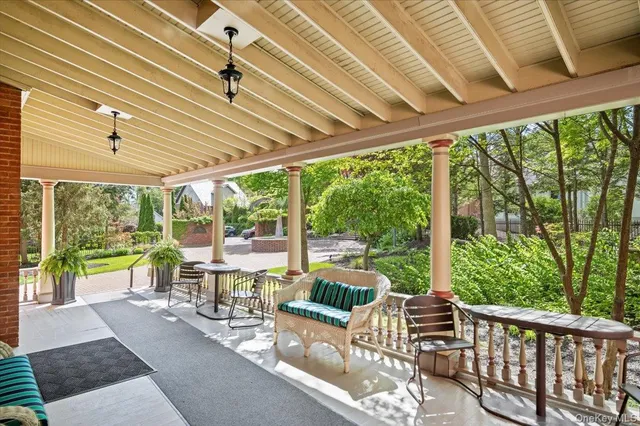 a view of a patio with a table chairs and backyard